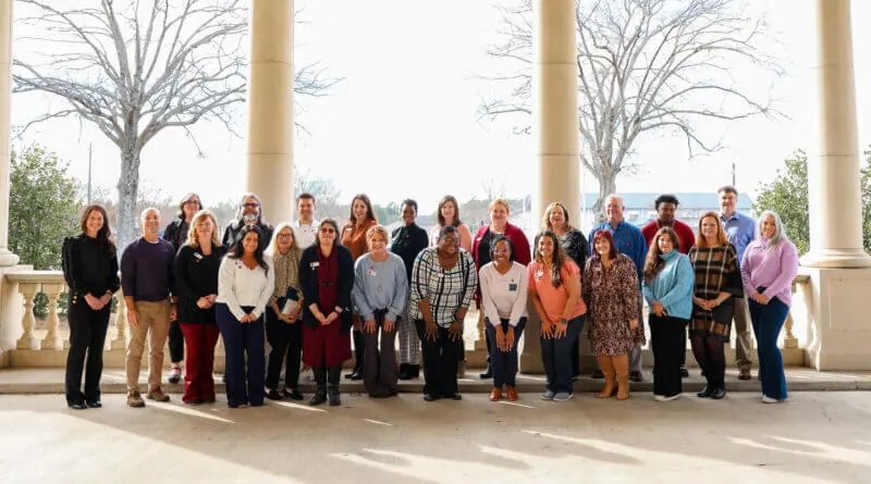 Group of NWCC faculty posing for a photo outdoors for an ACUE pinning ceremony.