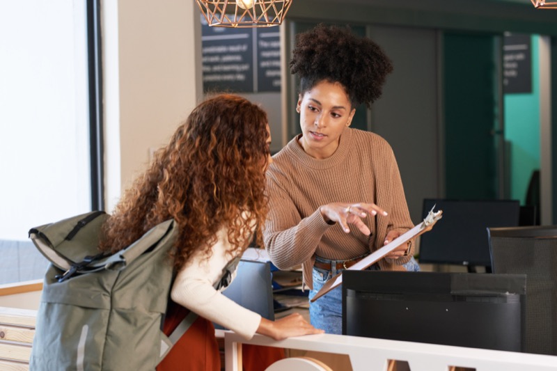 A teacher demonstrates great teaching by providing one-on-one support to a student, fostering an interactive learning environment.