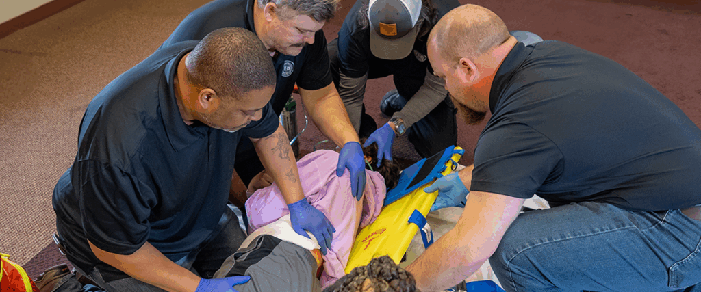 Instructor showing students how to work with an injured patient