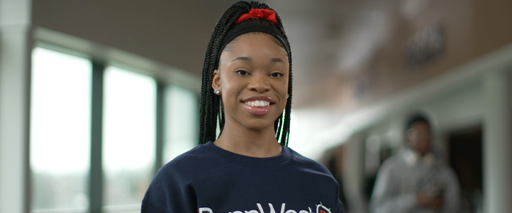 PASSHE student smiles at camera