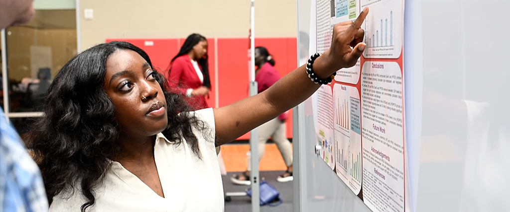 WSSU student pointing at her research findings